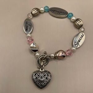 Silver tone gemstone bracelet with a heart pendant for a granddaughter.